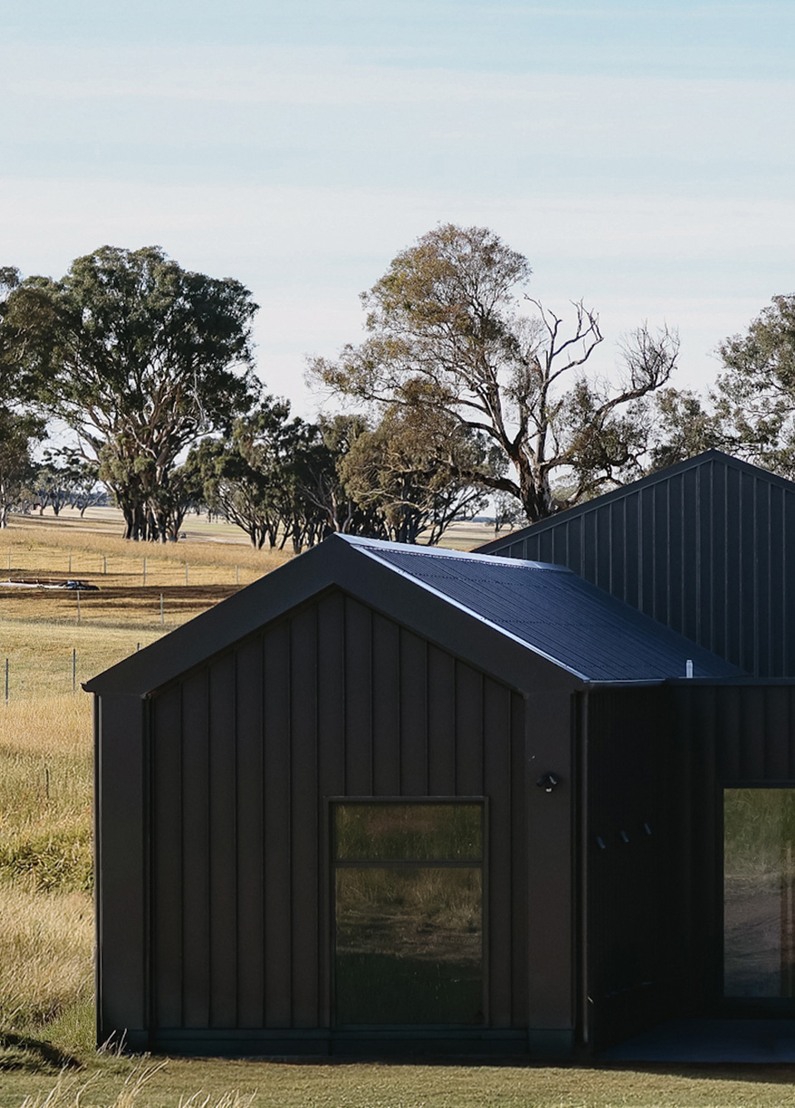 Black-clad country home with pitched roof, 34 Guise Street Project, Sutton ACT
