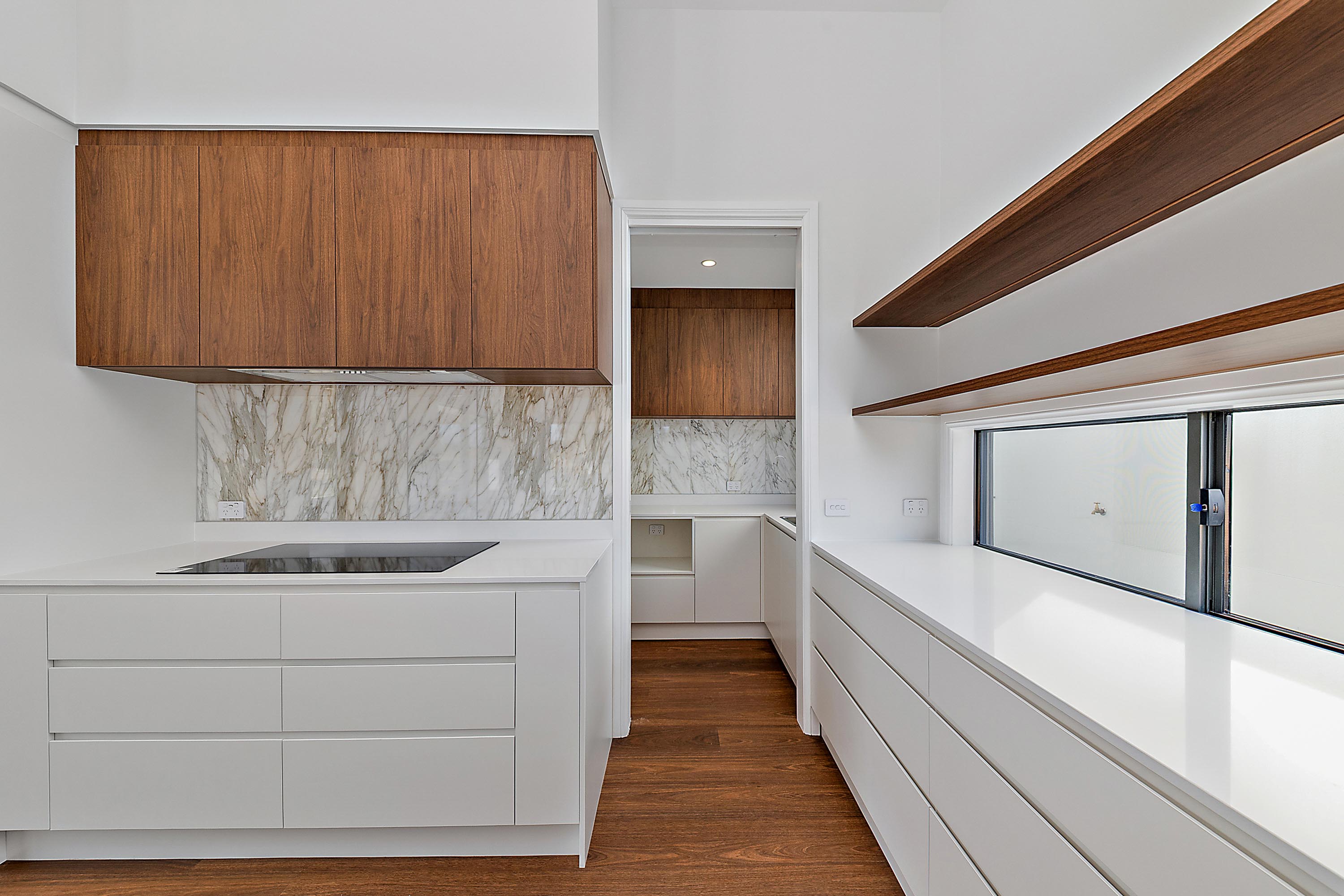 Modern kitchen with white cabinetry, timber overhead cabinets and marble splashback, 14 Blakelys Close Project, Sutton ACT