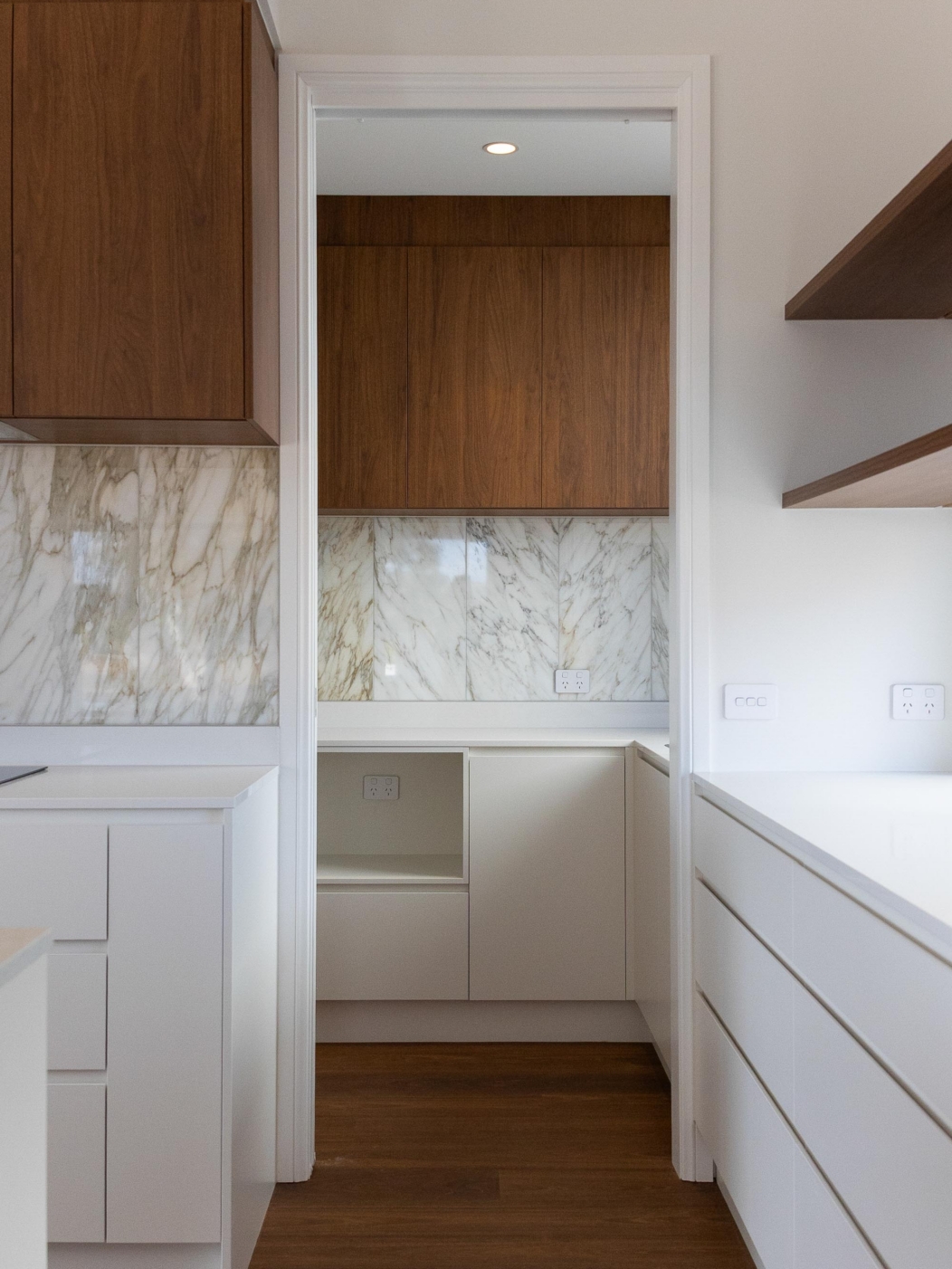 Modern kitchen with white cabinetry, timber overhead cabinets and marble splashback, 14 Blakelys Close Project, Sutton ACT
