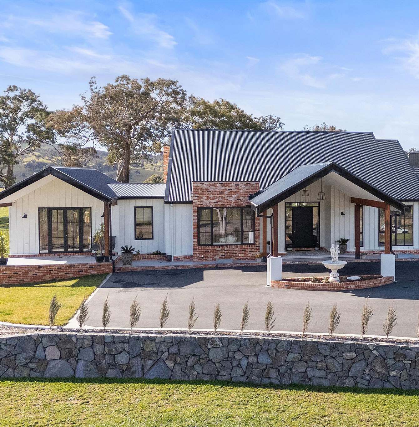 Modern country-style home with white cladding and brick exterior, Sutton Residence, Sutton ACT